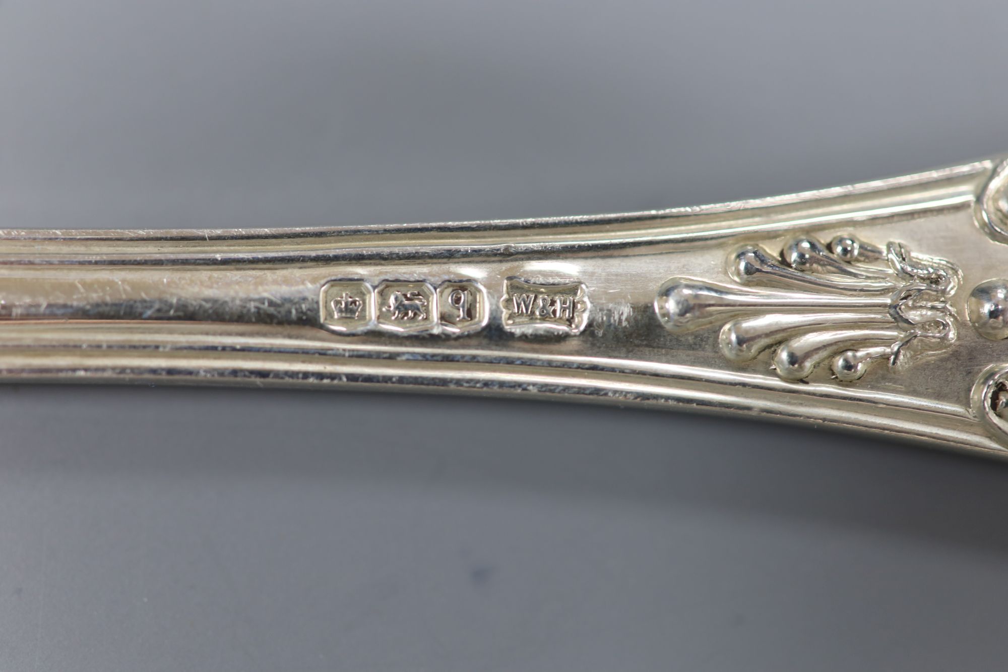 A set of eight George V silver Kings pattern soup spoons, Walker & Hall, Sheffield, 1933, 23.25oz.